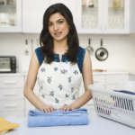 housekeeper cleaning kitchen counter