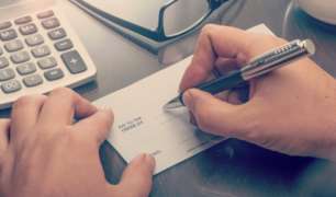 Homeowner Writing a Staff Member's Pay Check