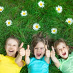 Kids lying in the grass in a NYC park