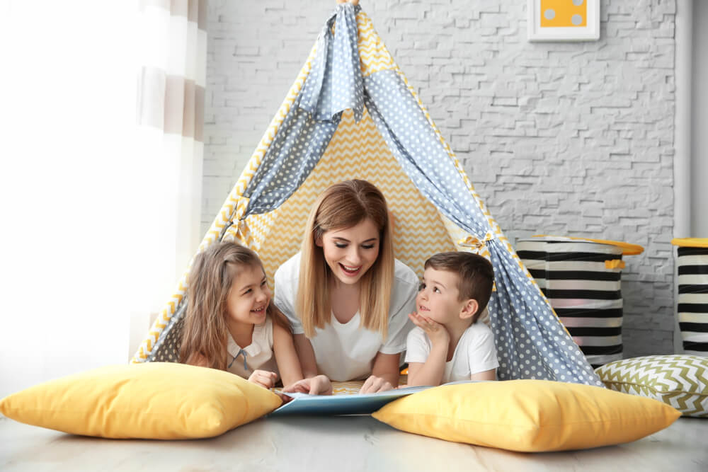 nanny with children at home in tent