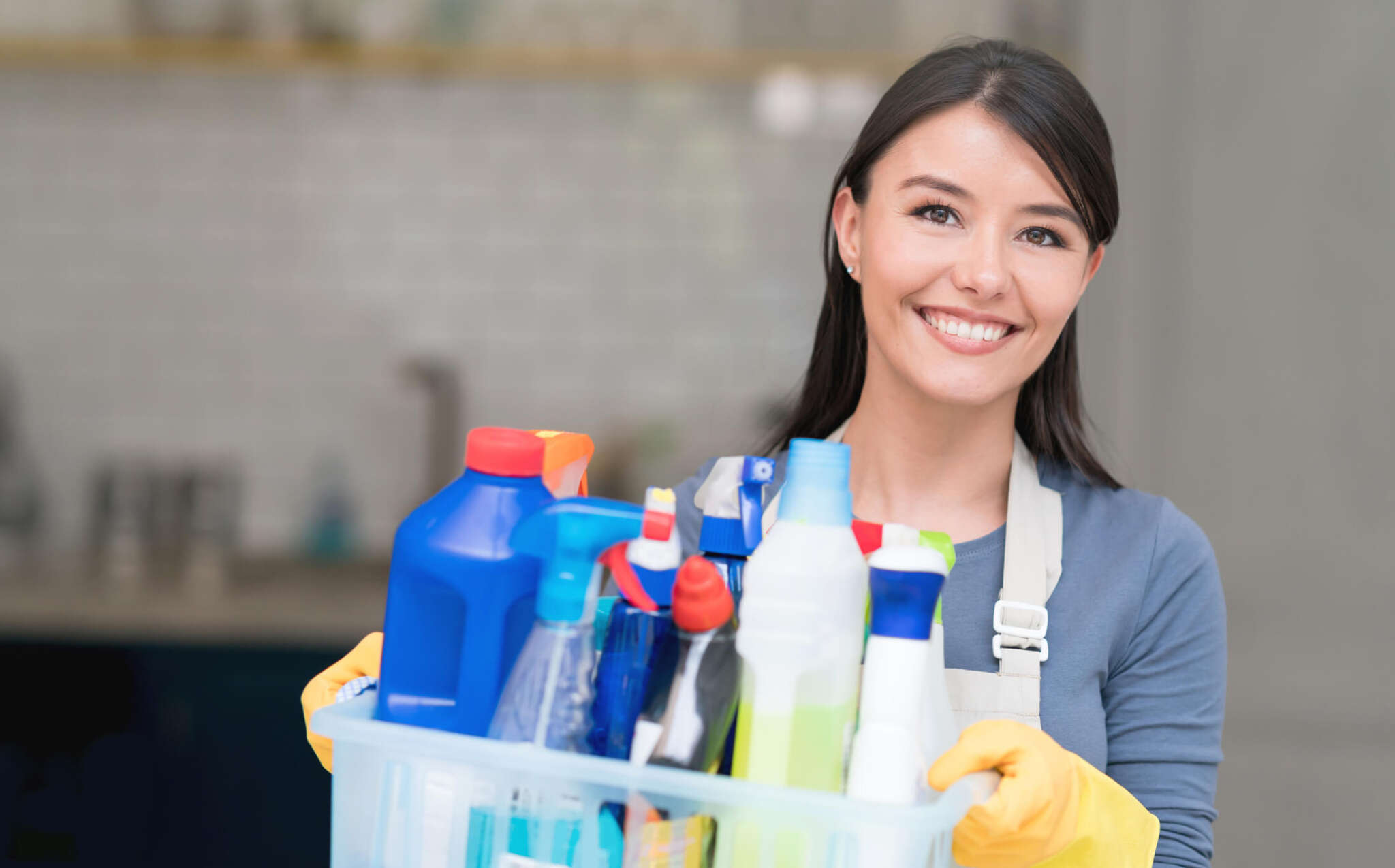 housecleaning woman holding supplies