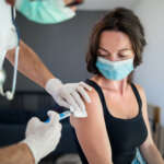 Woman with face mask getting vaccinated, coronavirus concept