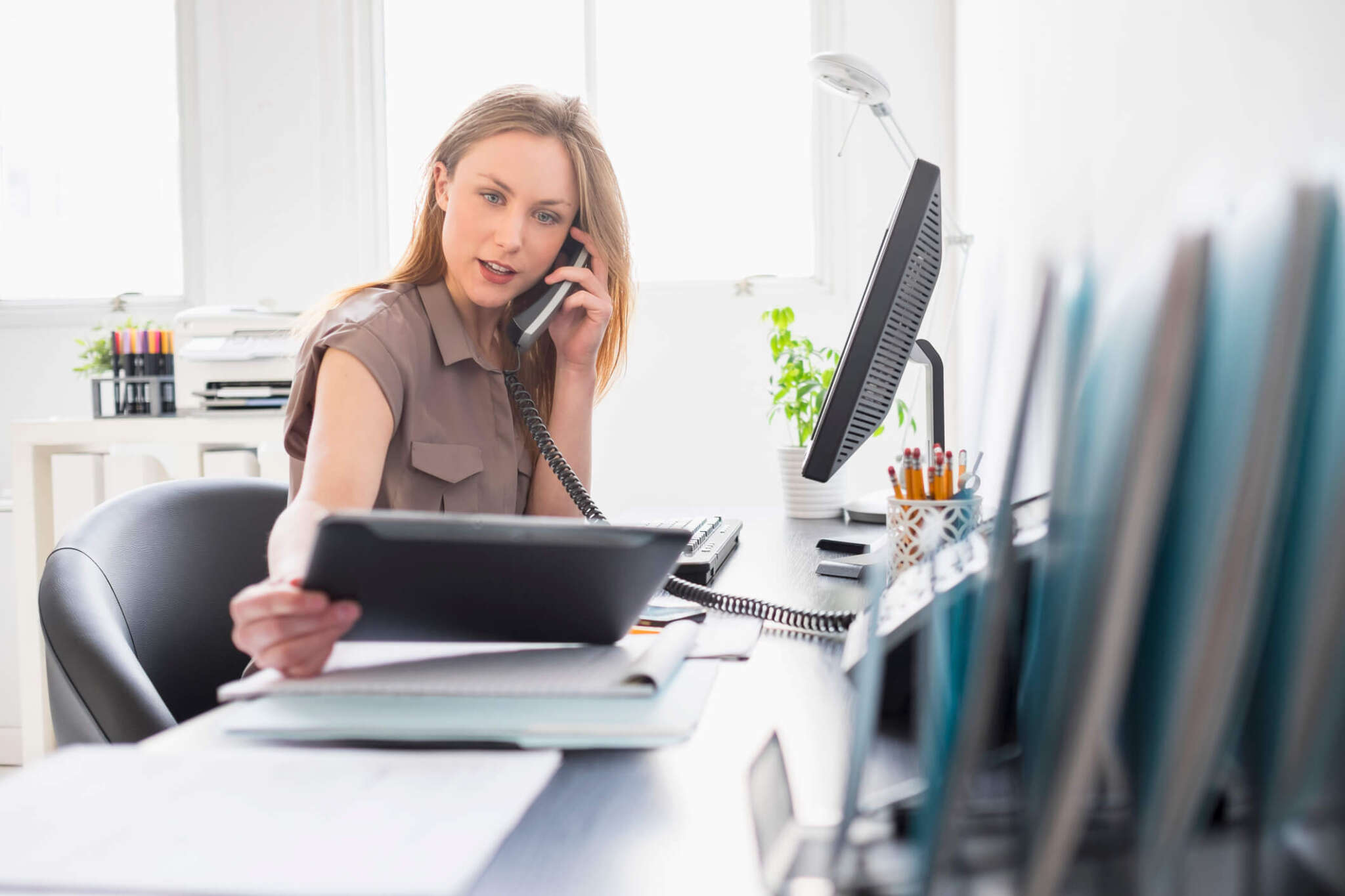 Portrait of young woman working in office, Jersey City, New Jersey, USA