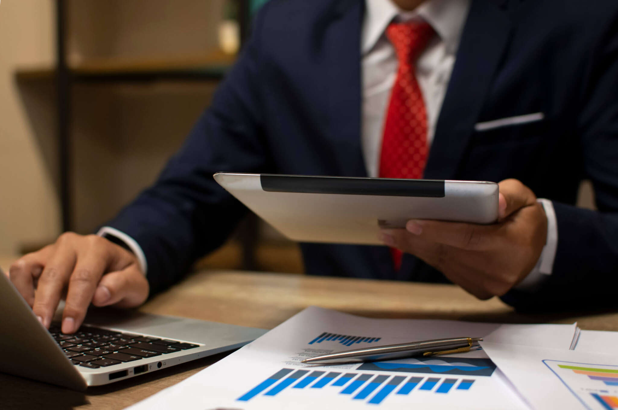 Man calculating budget numbers, Invoices and financial advise using a digital personal assistant.