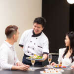 Private chef serving dinner to couple