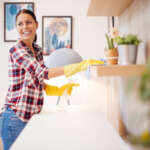 Housekeeper wiping shelves