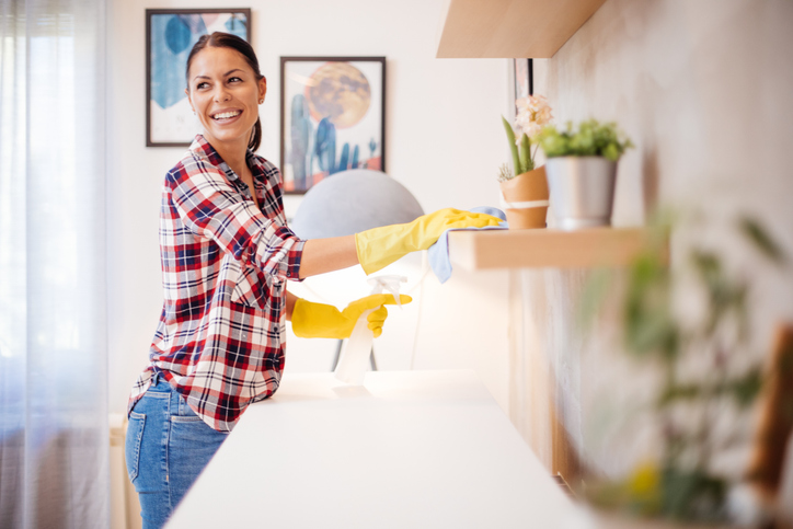 Housekeeper wiping shelves