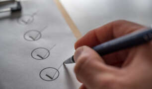 Deep cleaning checklist for housekeeper being marked off, showing organized seasonal home cleaning tasks.
