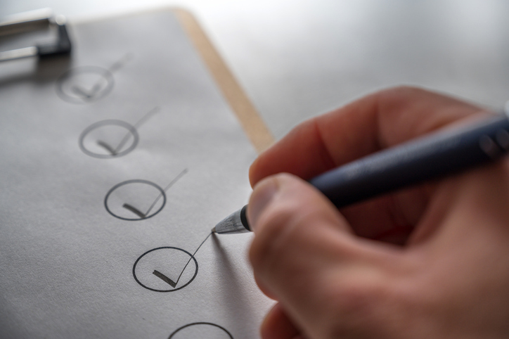 Deep cleaning checklist for housekeeper being marked off, showing organized seasonal home cleaning tasks.