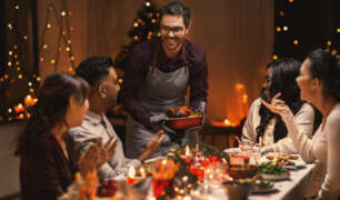 A private chef serves a festive holiday meal to a group celebrating seasonal traditions together.