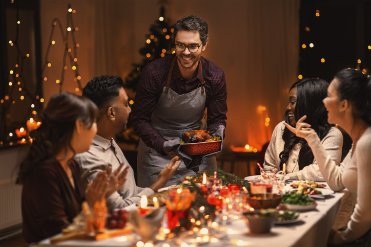 A private chef serves a festive holiday meal to a group celebrating seasonal traditions together.