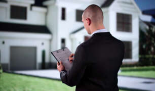 Estate manager reviewing property operations outside a luxury home residence