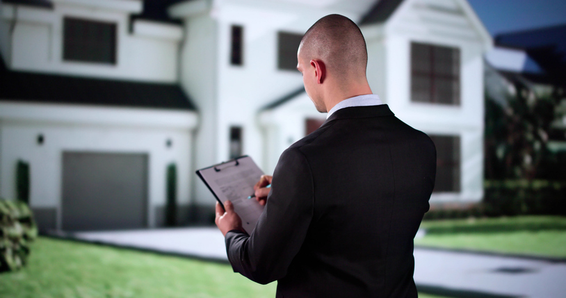 Estate manager reviewing property operations outside a luxury home residence